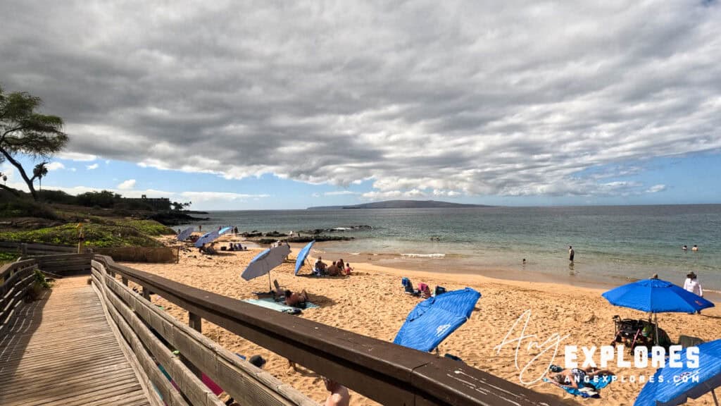 People sitting at Kamaole Beach Park III in Kihei, south Maui Hawaii