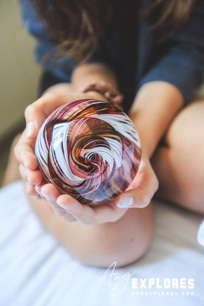 pink white and gold glass paperweight
