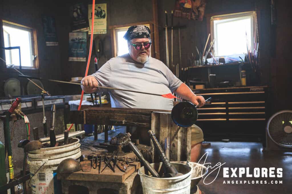 Artist creating glass vase in Lincoln City